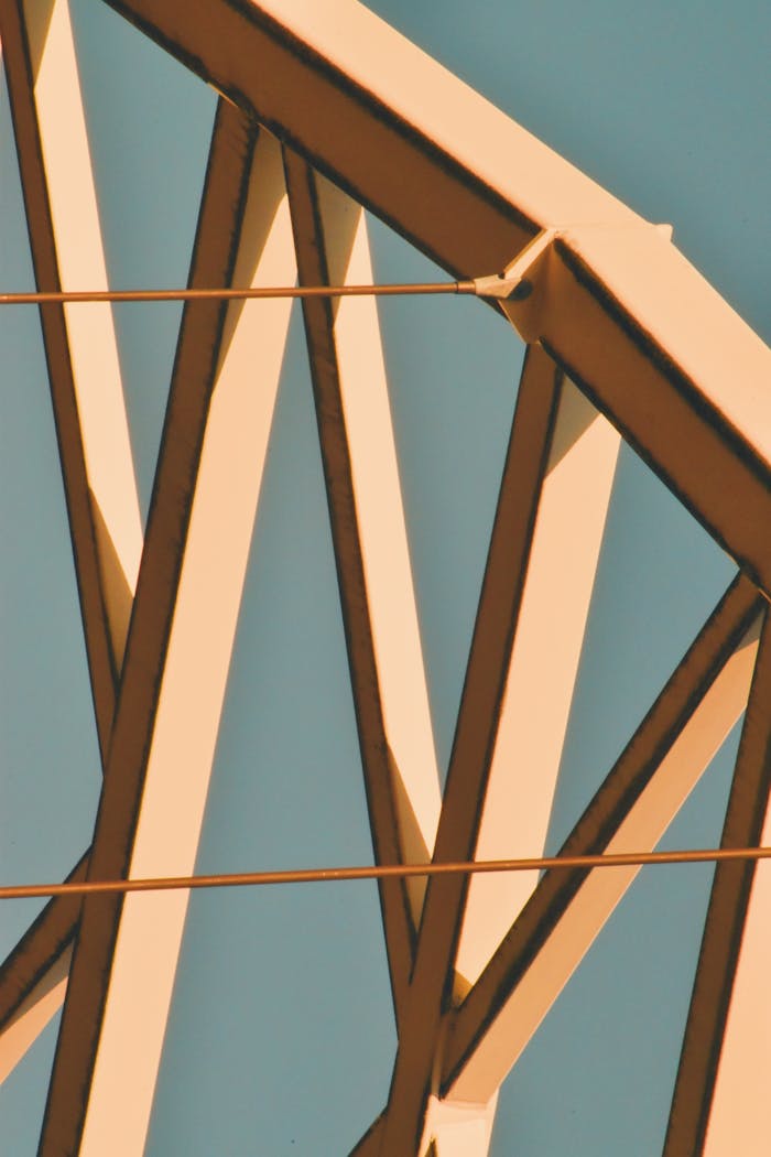 Close-up view of a steel structure with geometric design against a clear sky.